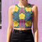 Honey Dazed Brand body-hugging racerback crop top featuring retro floral print with bright yellow flowers, pink geometric patterns, and blue swirls on dark background in performance knit fabric